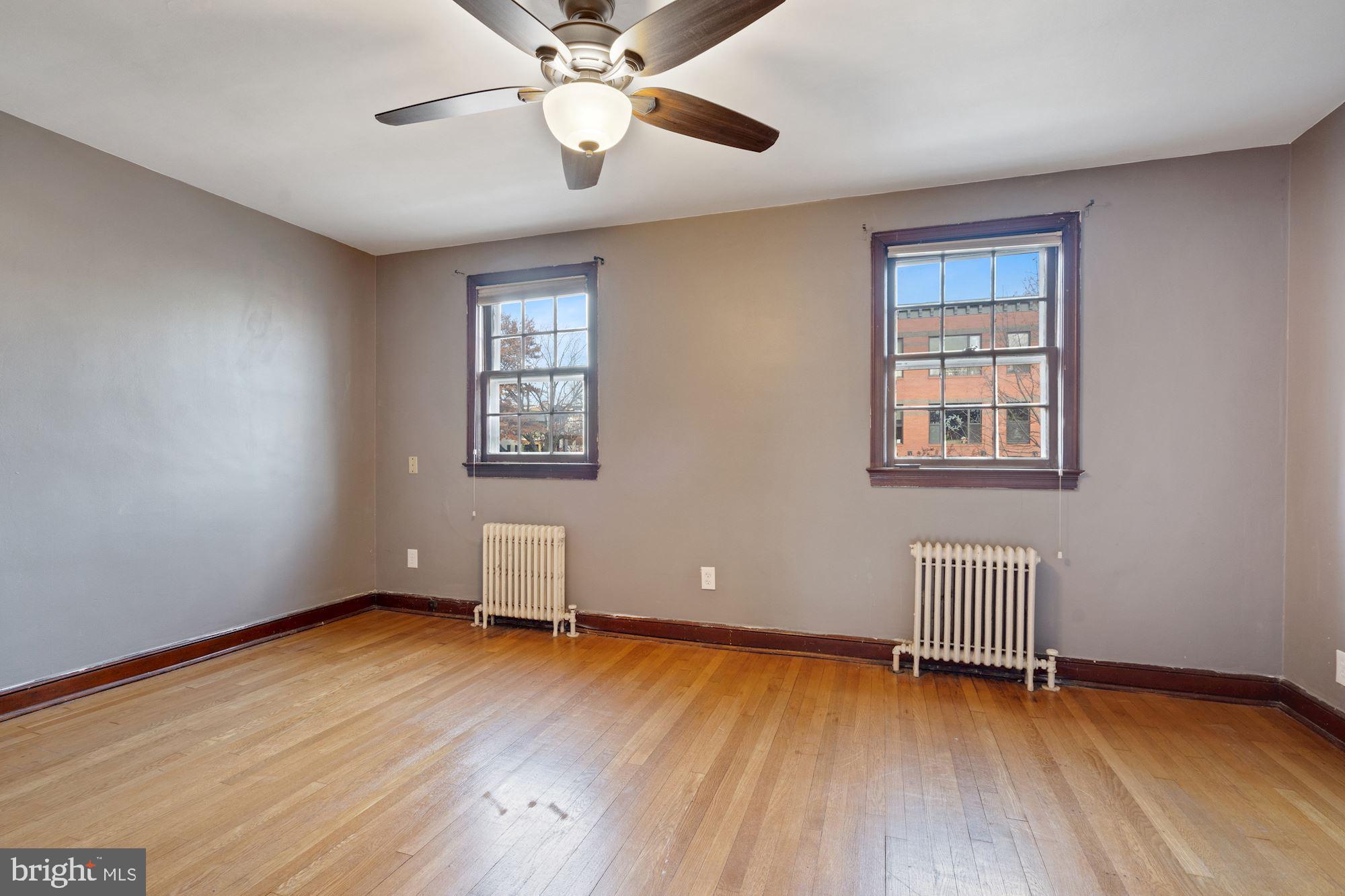 1403 K Street Southeast Washington, DC 20003 - Photo 31 of 74 a view of room with wooden floor and ceiling fan