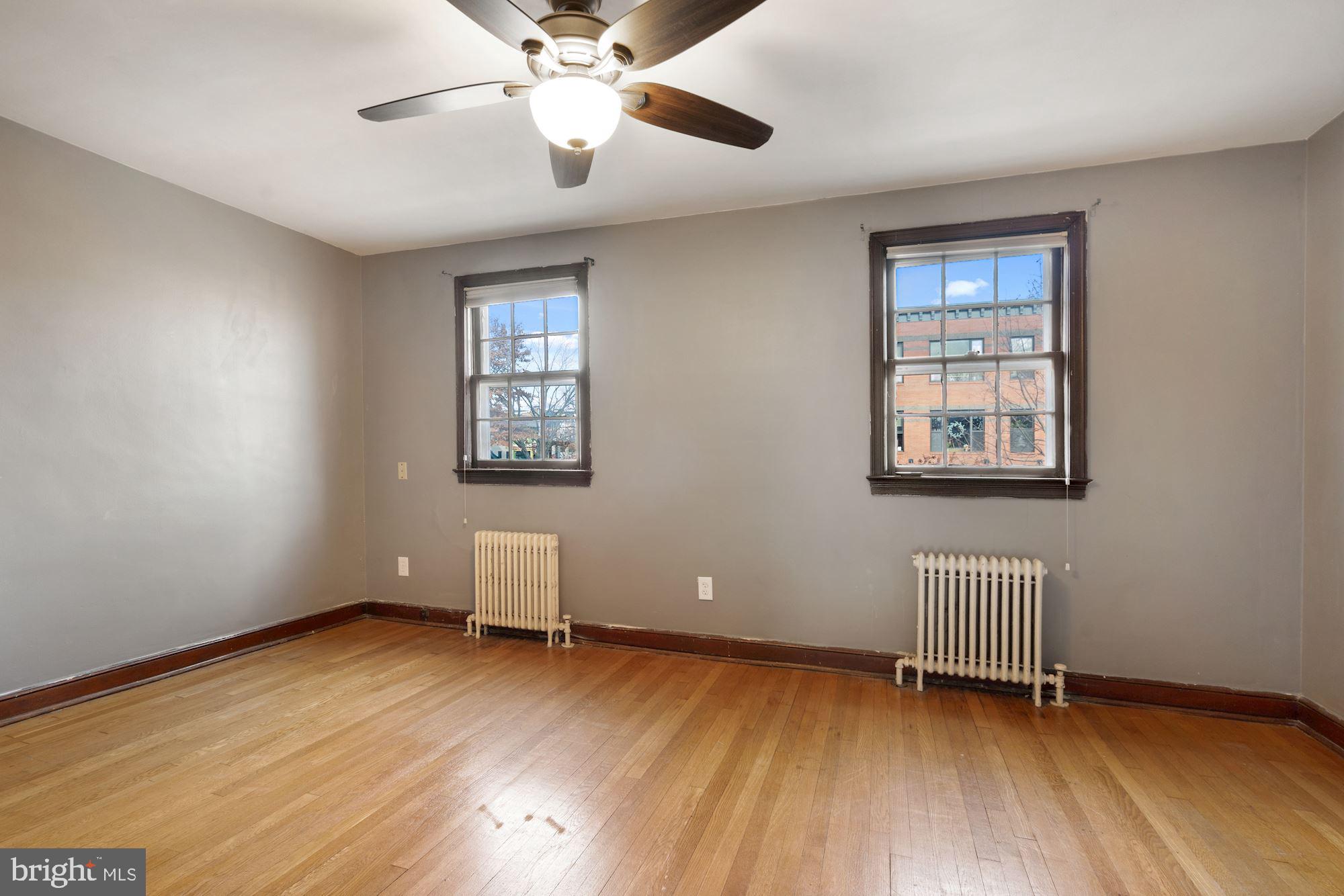 1403 K Street Southeast Washington, DC 20003 - Photo 45 of 74 a view of an empty room with window and wooden floor