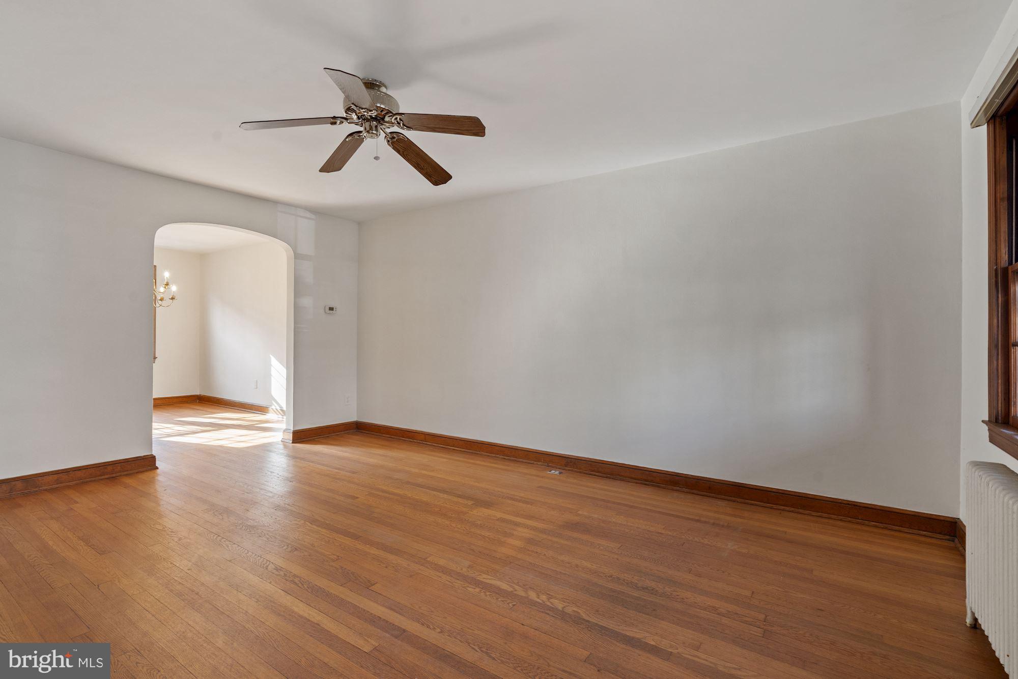 1403 K Street Southeast Washington, DC 20003 - Photo 53 of 74 a view of an empty room with wooden floor and a ceiling fan