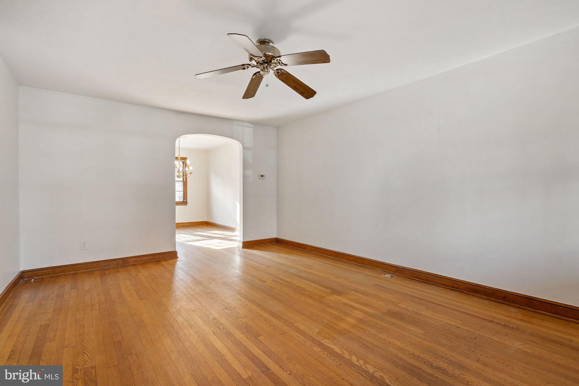 1403 K Street Southeast Washington, DC 20003 - Photo 56 of 74 a view of an empty room with wooden floor and a ceiling fan