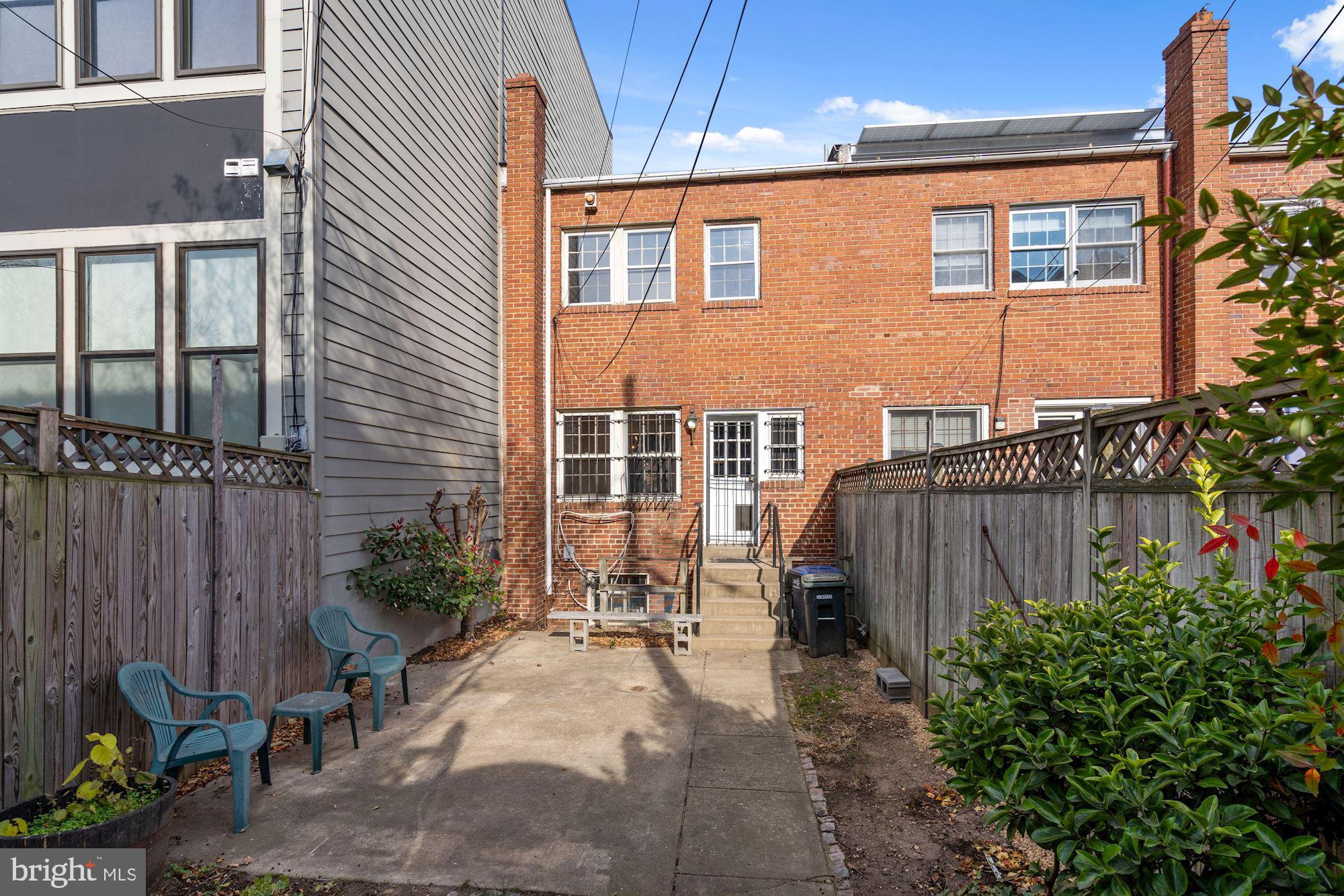 1403 K Street Southeast Washington, DC 20003 - Photo 74 of 74 a backyard of a house with chairs plants and wooden fence