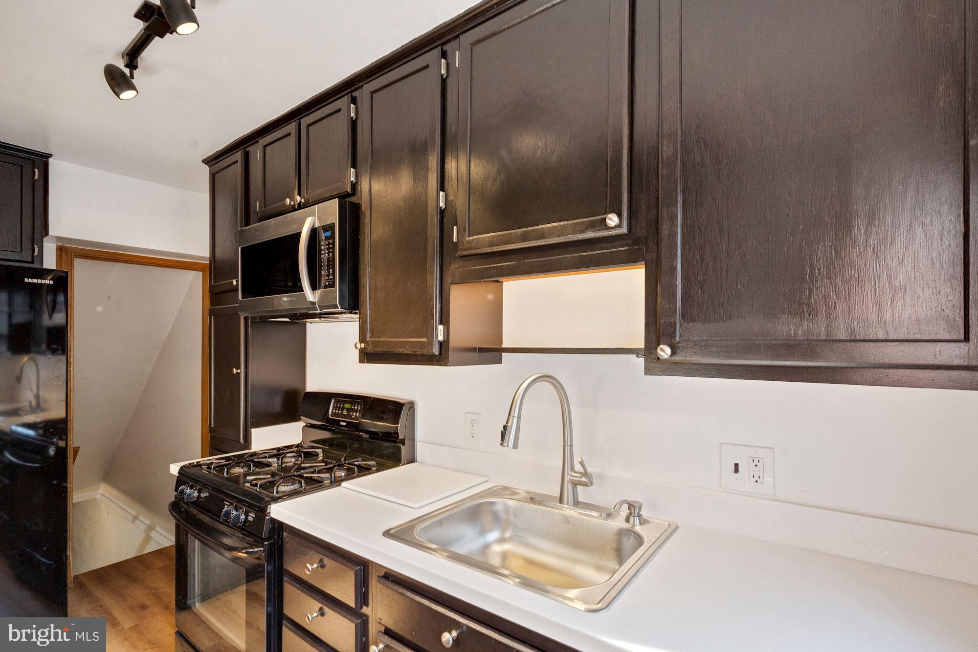 1403 K Street Southeast Washington, DC 20003 - Photo 9 of 74 a kitchen with stainless steel appliances granite countertop a sink stove and refrigerator
