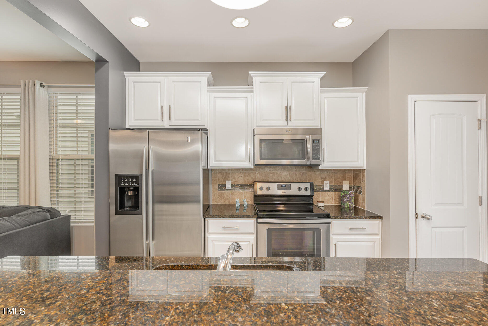 3743 Landshire View Lane Raleigh, NC 27616 - Photo 11 of 28 a kitchen with stainless steel appliances kitchen island granite countertop a refrigerator and a stove