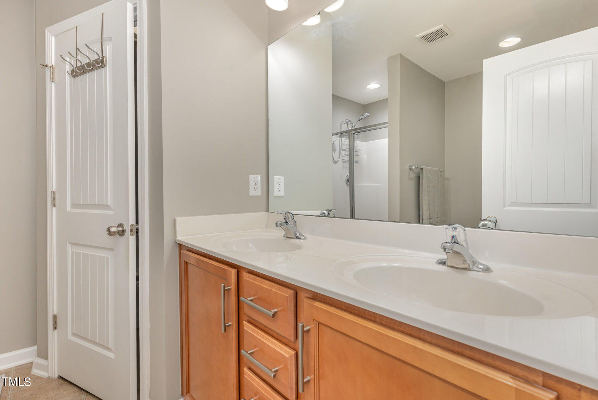3743 Landshire View Lane Raleigh, NC 27616 - Photo 16 of 28 a bathroom with a double vanity sink and a mirror