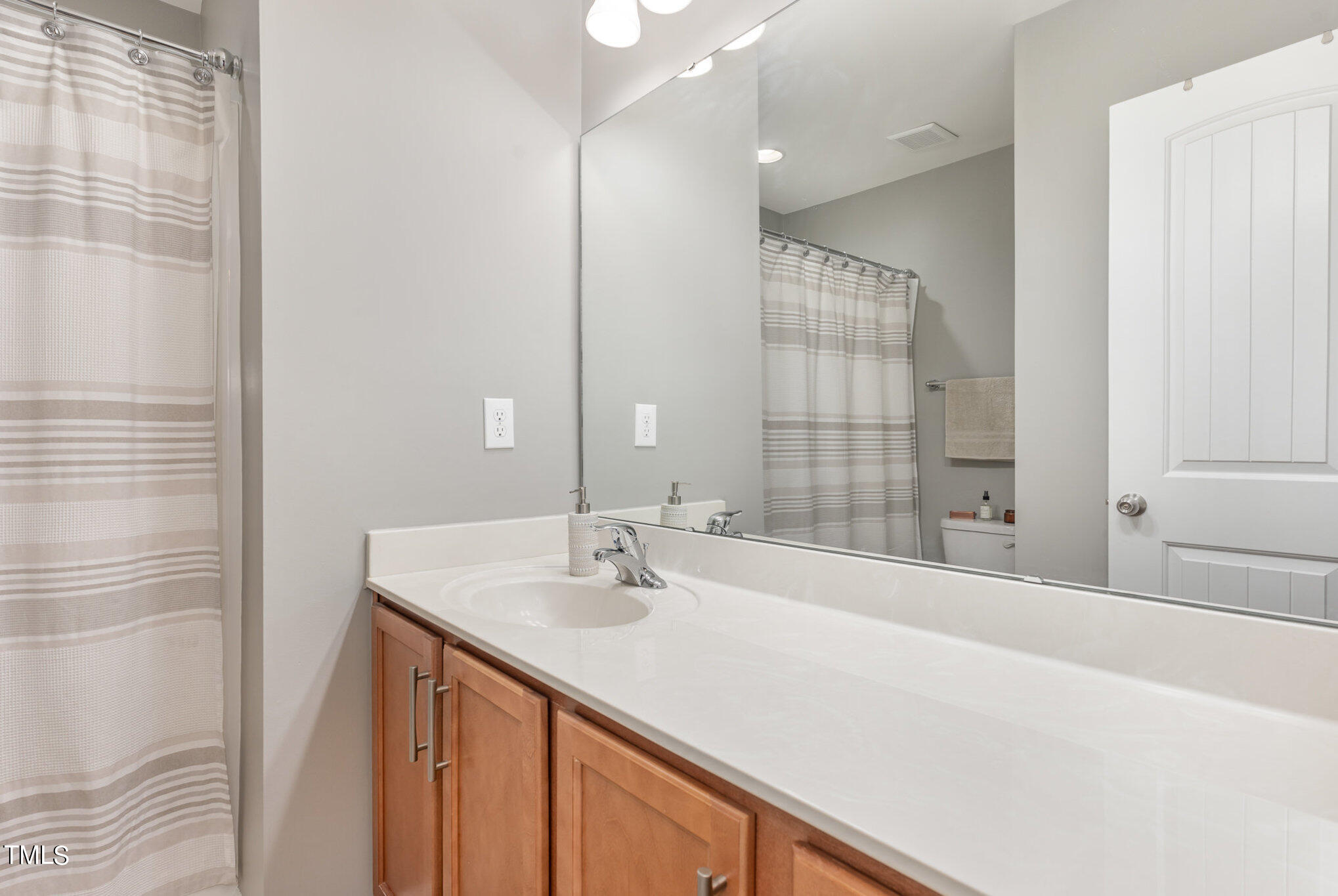 3743 Landshire View Lane Raleigh, NC 27616 - Photo 22 of 28 a bathroom with a sink and a mirror