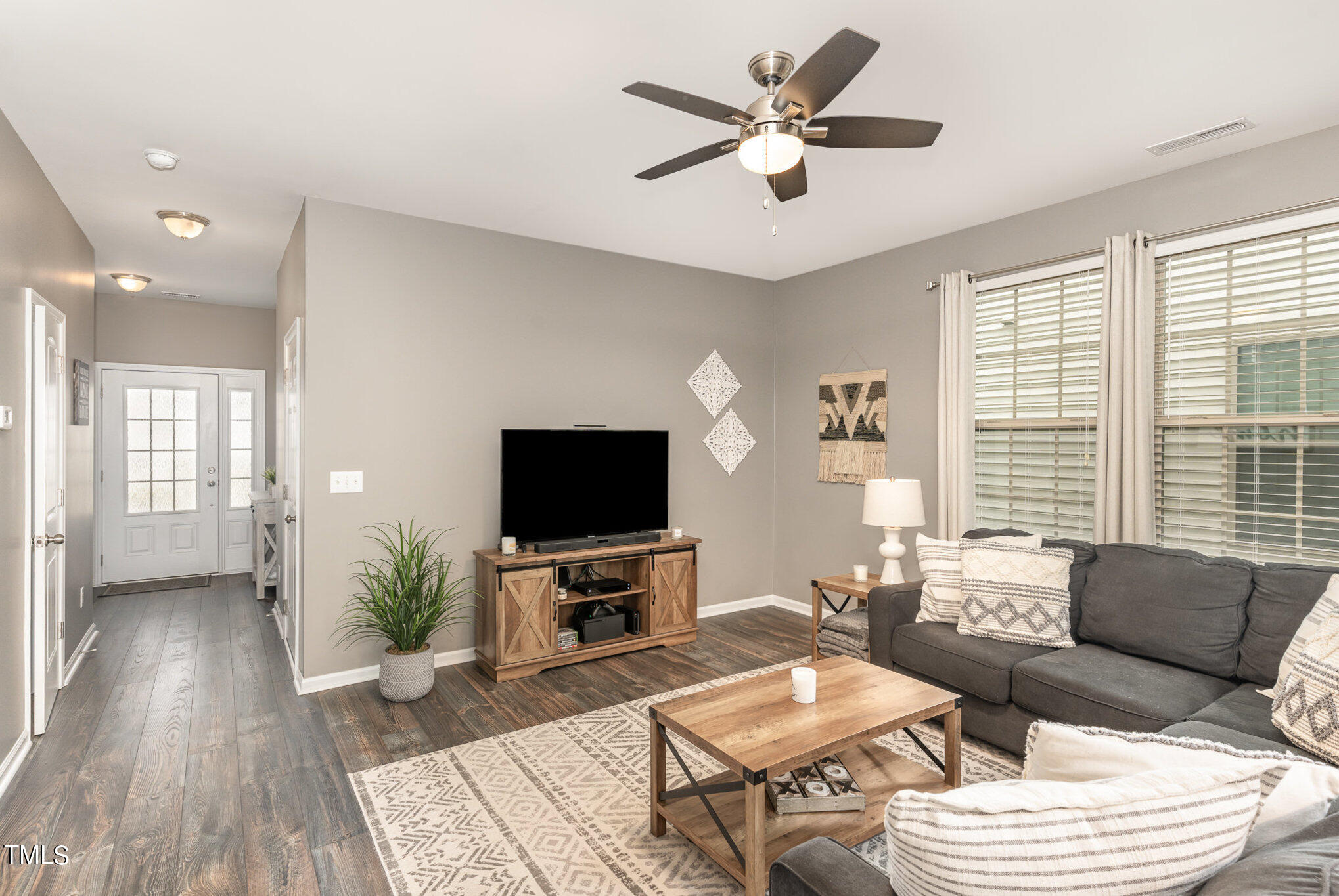 3743 Landshire View Lane Raleigh, NC 27616 - Photo 6 of 28 a living room with furniture a flat screen tv and a large window
