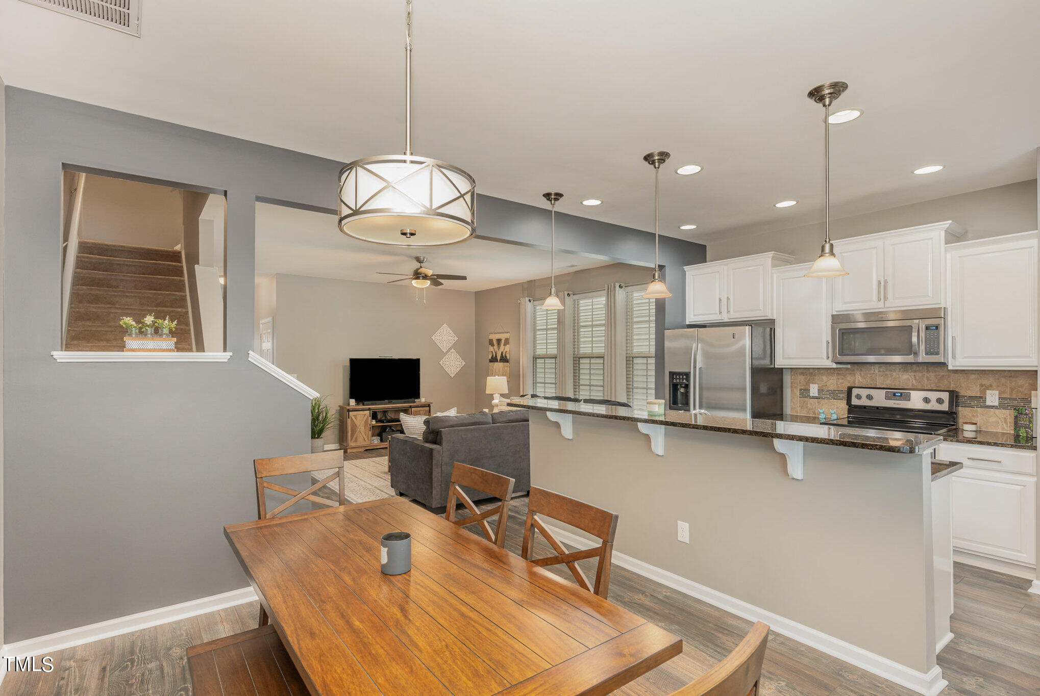 3743 Landshire View Lane Raleigh, NC 27616 - Photo 8 of 28 a room with stainless steel appliances lots of wooden furniture