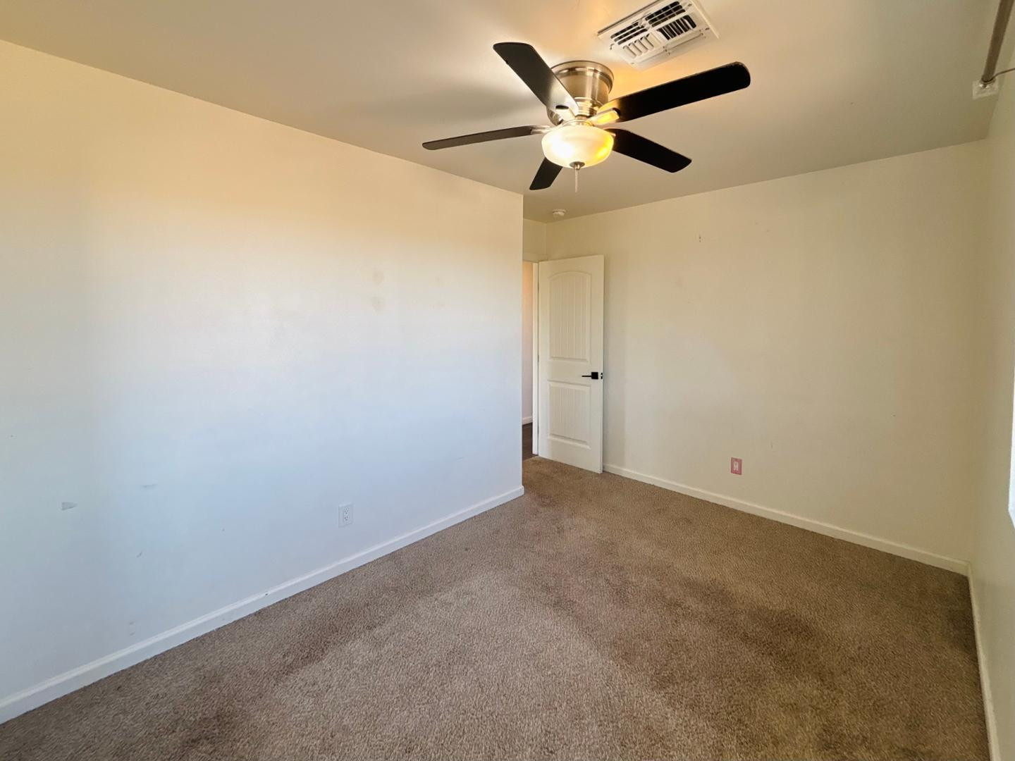 1750 West Pearce Road Phoenix, AZ 85041 - Photo 30 of 39 an empty room with a window and a fan