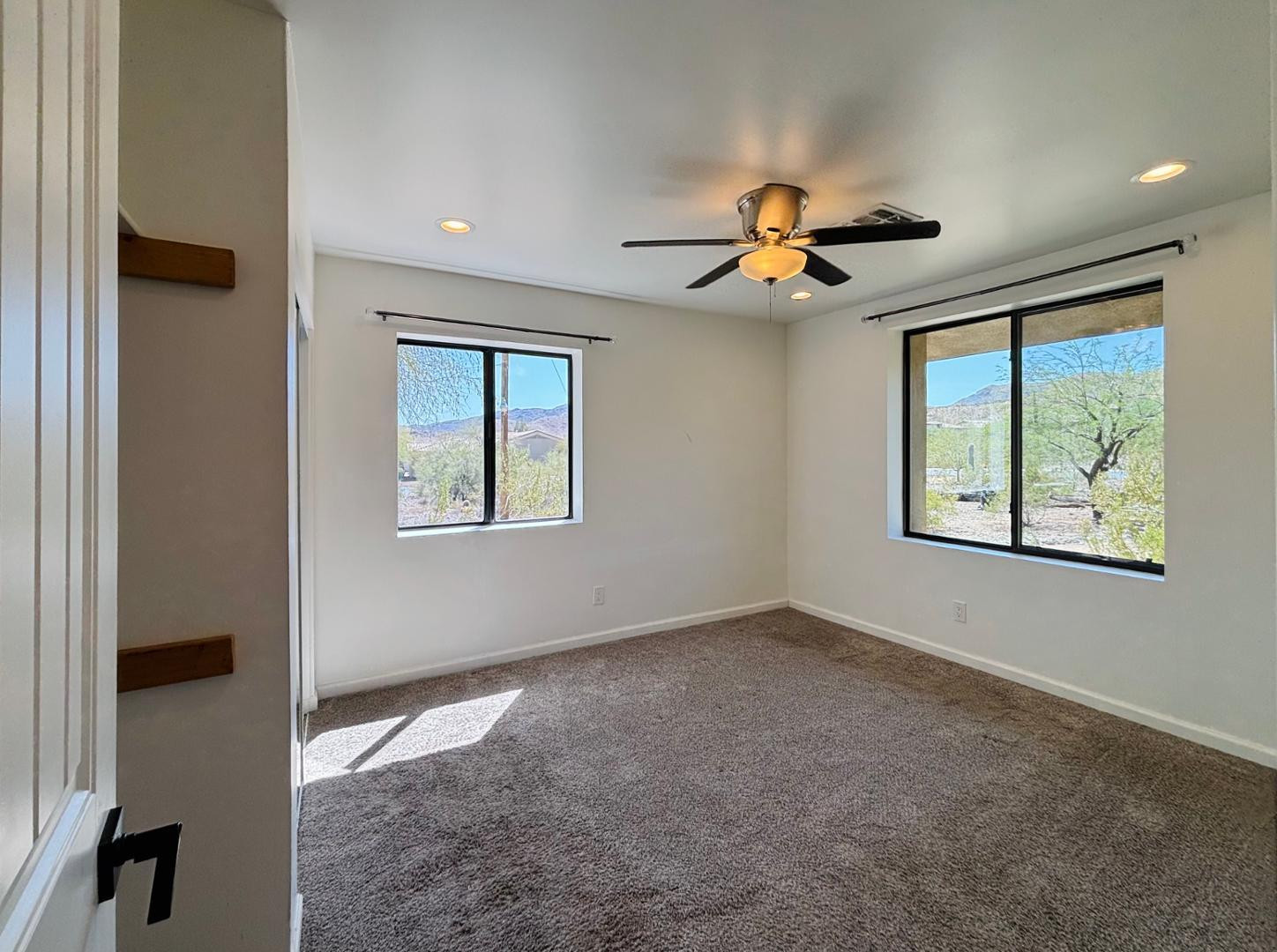 1750 West Pearce Road Phoenix, AZ 85041 - Photo 34 of 39 an empty room with windows and ceiling fan