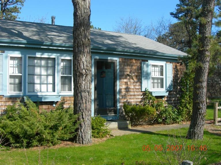 101 Lower County Road, Unit 3B Dennis Port, MA 02639 - Photo 1 of 8 a front view of a house with a yard