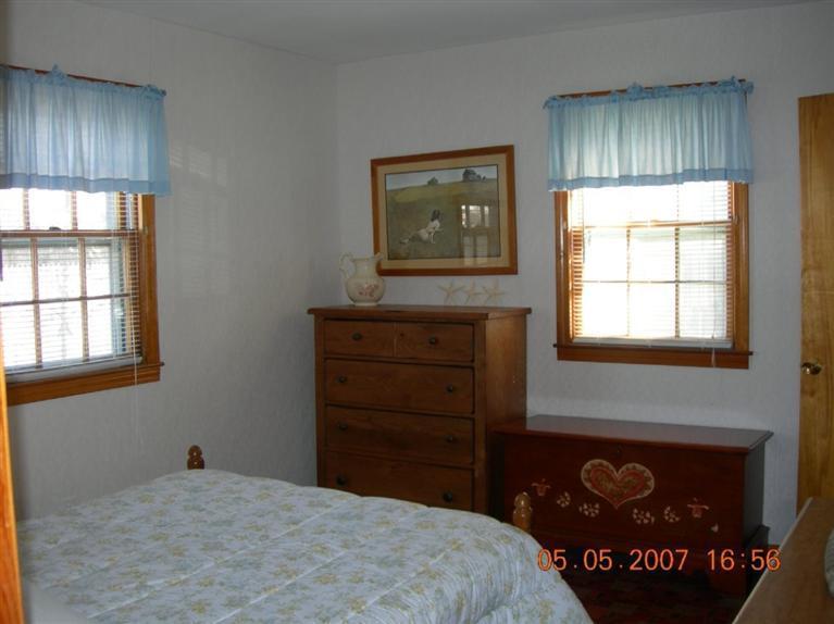 101 Lower County Road, Unit 3B Dennis Port, MA 02639 - Photo 7 of 8 a bedroom with a bed and a window