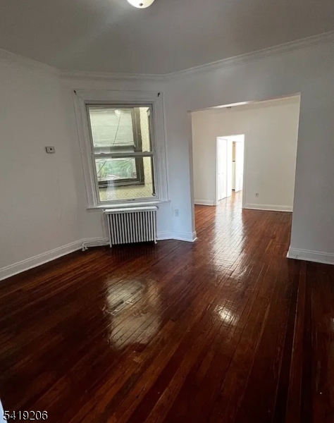 1254 Paterson Plank Road, Unit 2B Secaucus, NJ 07094 - Photo 2 of 5 a view of an empty room with wooden floor and a window
