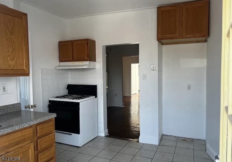 1254 Paterson Plank Road, Unit 2B Secaucus, NJ 07094 - Photo 5 of 5 a kitchen with stainless steel appliances granite countertop a refrigerator and a stove
