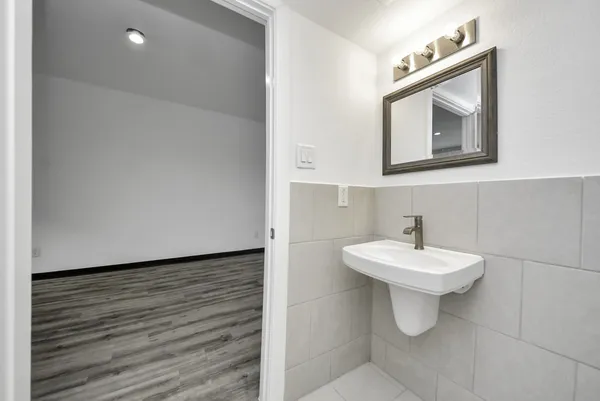 a bathroom with a toilet sink and mirror