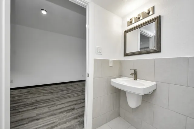 a bathroom with a toilet sink and mirror