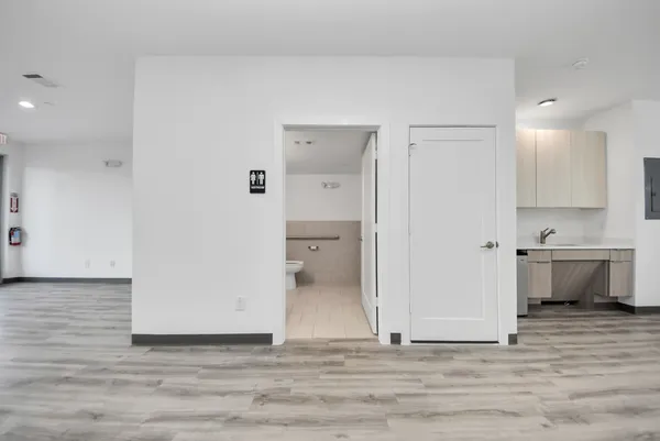 a view of a kitchen with a sink and a refrigerator
