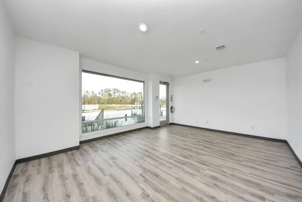 a view of wooden floor and windows in a room