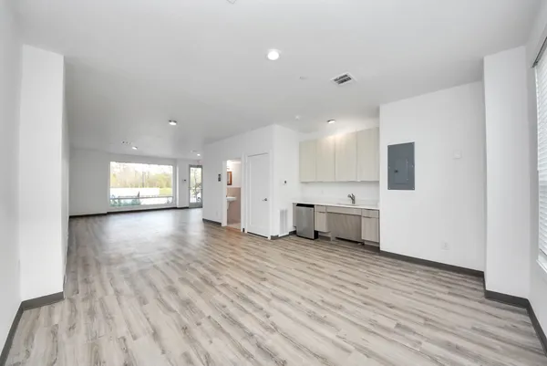 a view of a kitchen with a sink and a refrigerator