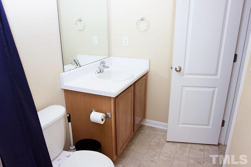 3537 Londonville Lane Raleigh, NC 27604 - Photo 11 of 21 a bathroom with a sink a toilet a mirror and vanity