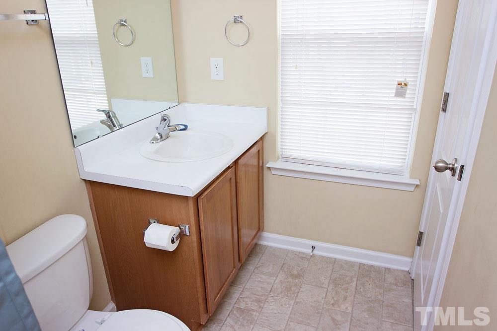 3537 Londonville Lane Raleigh, NC 27604 - Photo 15 of 21 a bathroom with a sink a toilet and a mirror