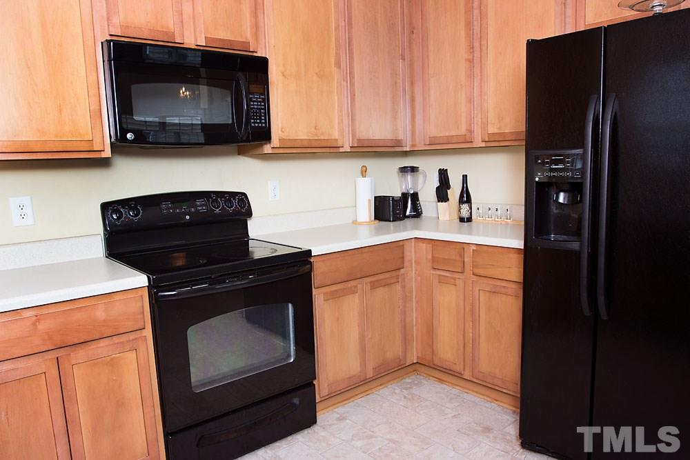 3537 Londonville Lane Raleigh, NC 27604 - Photo 3 of 21 a kitchen with stainless steel appliances granite countertop a stove a refrigerator and a microwave