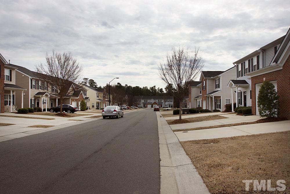 3537 Londonville Lane Raleigh, NC 27604 - Photo 21 of 21 a city street lined with buildings and cars parked on the roadside