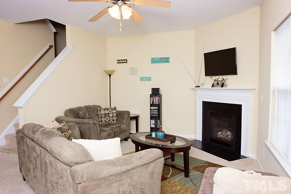 3537 Londonville Lane Raleigh, NC 27604 - Photo 4 of 21 a living room with furniture a flat screen tv and a fireplace