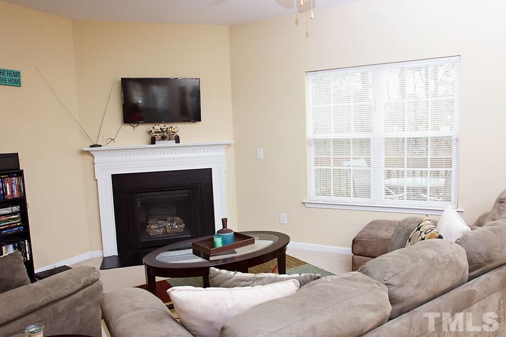 3537 Londonville Lane Raleigh, NC 27604 - Photo 5 of 21 a living room with furniture a flat screen tv and a fireplace