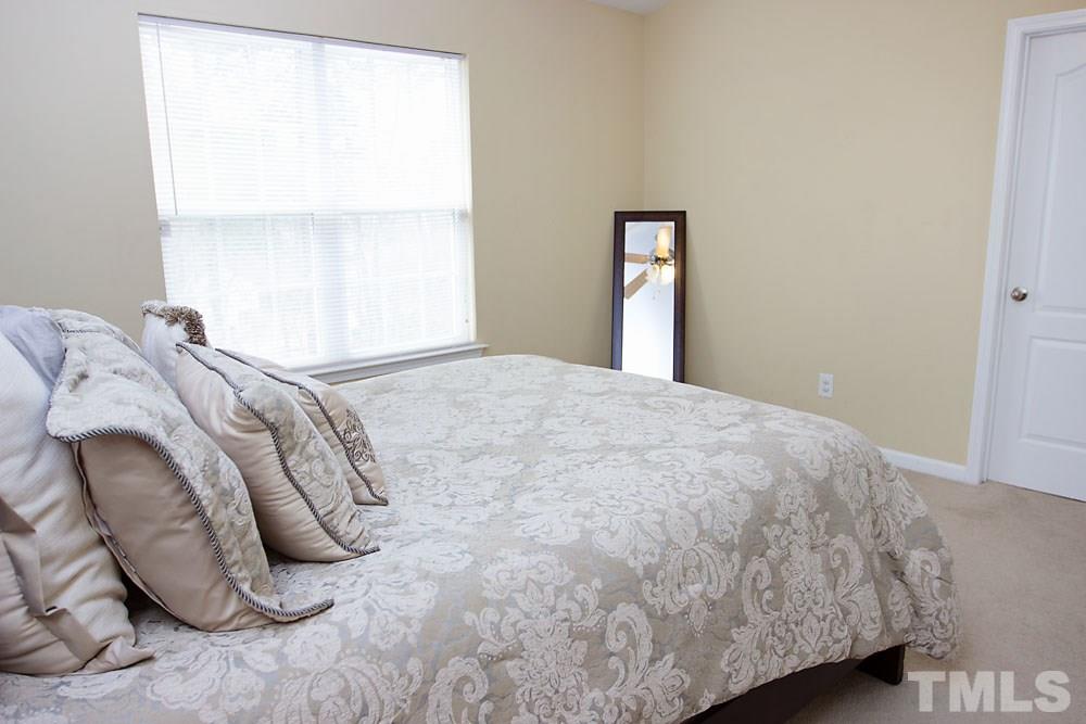 3537 Londonville Lane Raleigh, NC 27604 - Photo 9 of 21 a bed sitting in a bedroom next to a window
