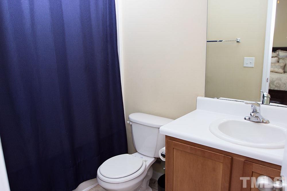 3537 Londonville Lane Raleigh, NC 27604 - Photo 10 of 21 a bathroom with a sink a toilet and a mirror