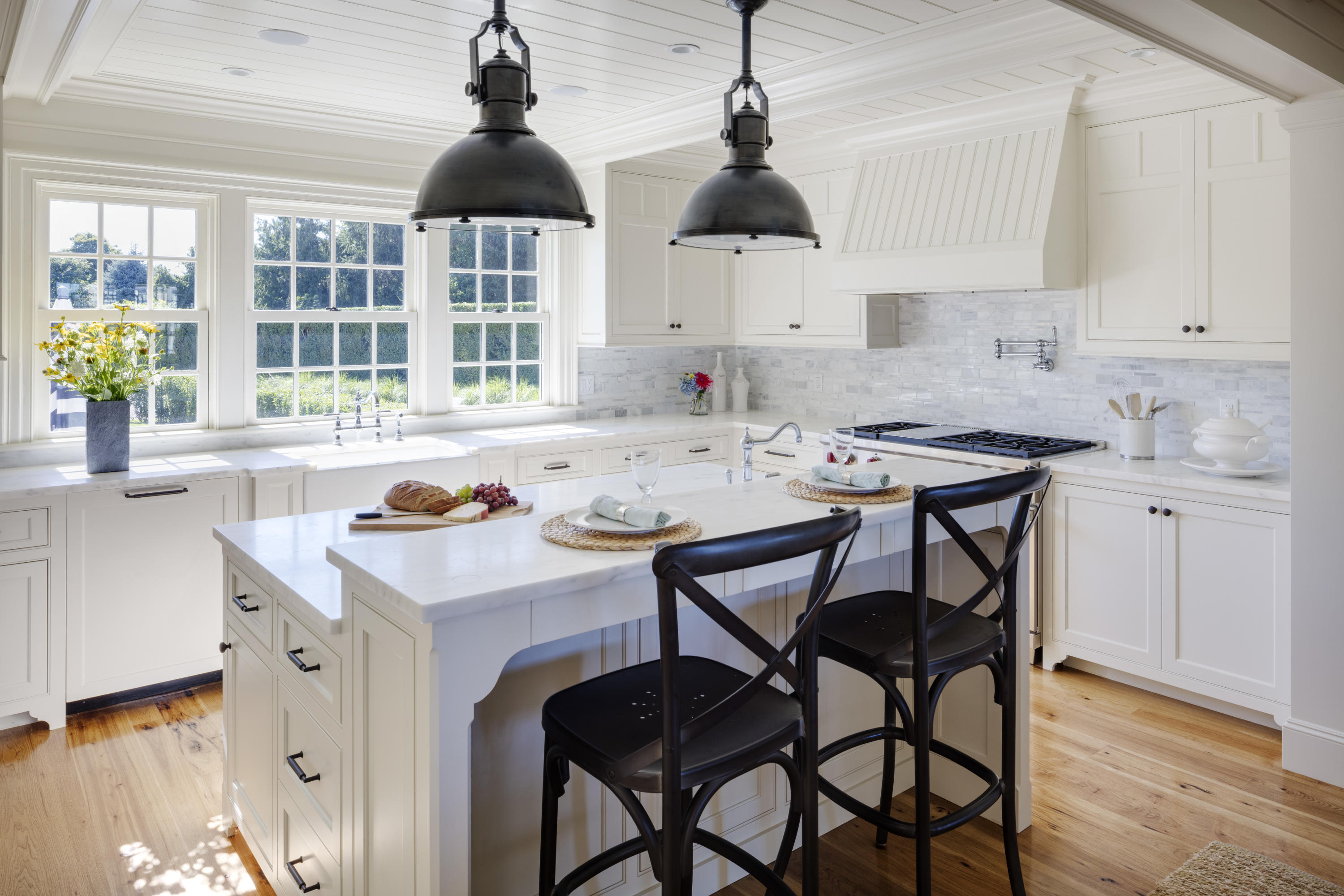 103 Shore Road Chatham, MA 02633 - Photo 10 of 32 a kitchen with a dining table chairs and white cabinets