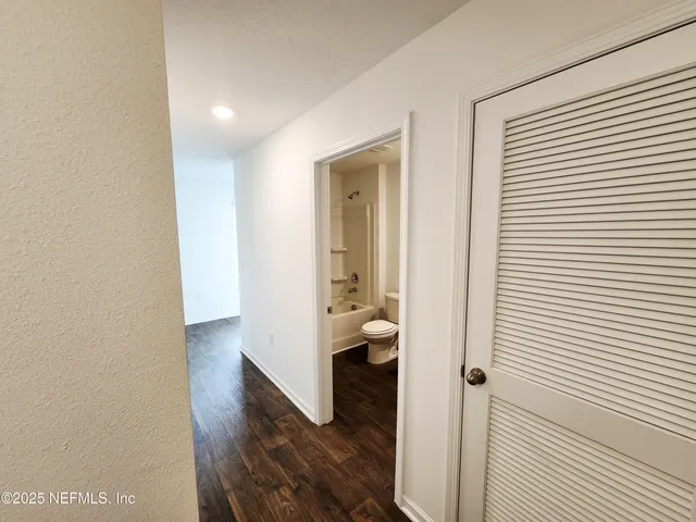 an empty room with closet and mirror