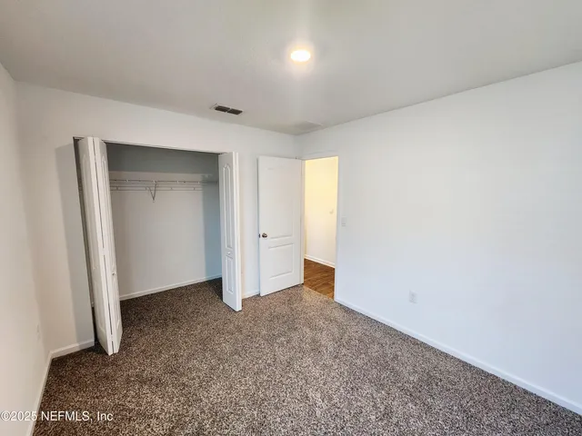 a spacious bathroom with a double vanity sink and a mirror