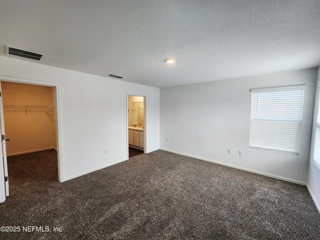 a view of a backyard with wooden fence