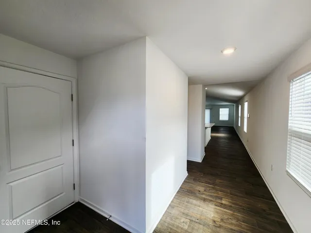 a view of a hallway with the wooden floor and staircase