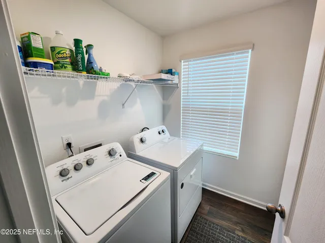 an empty room with wooden floor and entrance