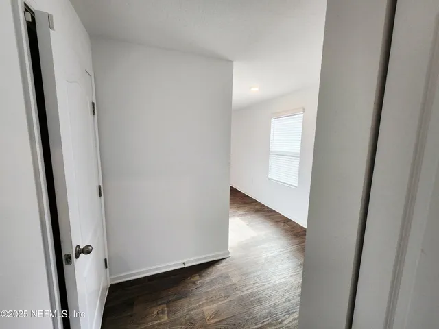 a view of an empty room and wooden floor