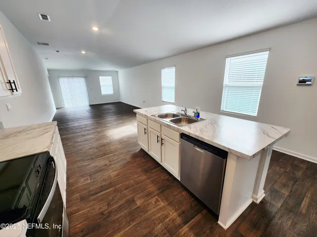 a view of a big room with closet and windows