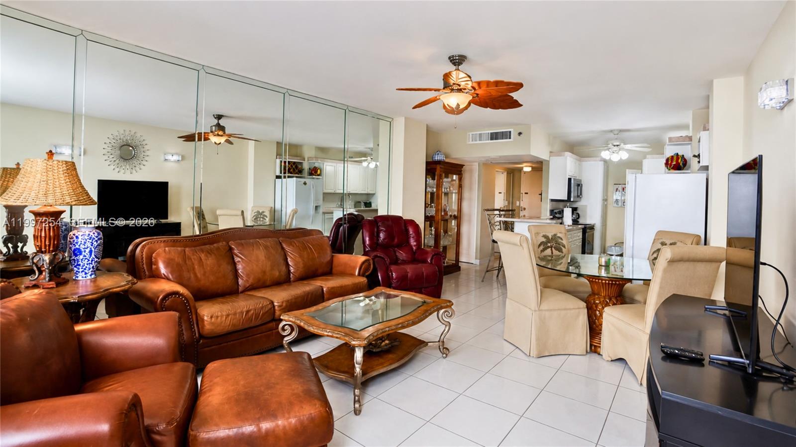 100 Lincoln Road, Unit 422 Miami Beach, FL 33139 - Photo 2 of 23 a living room with furniture a flat screen tv and kitchen view