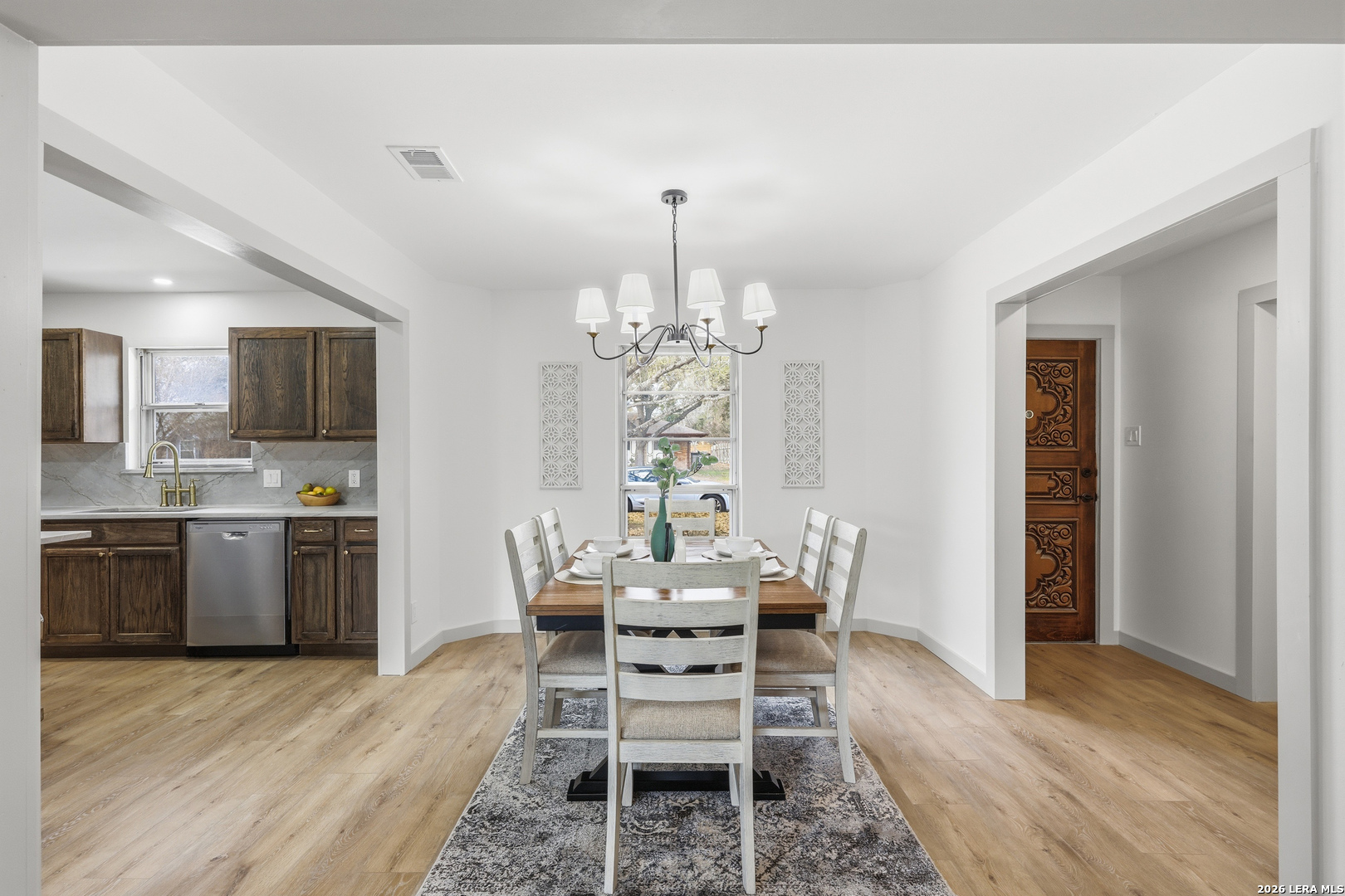 426 Zephyr Drive Windcrest, TX 78239 - Photo 13 of 33 a dining room with furniture a chandelier and wooden floor