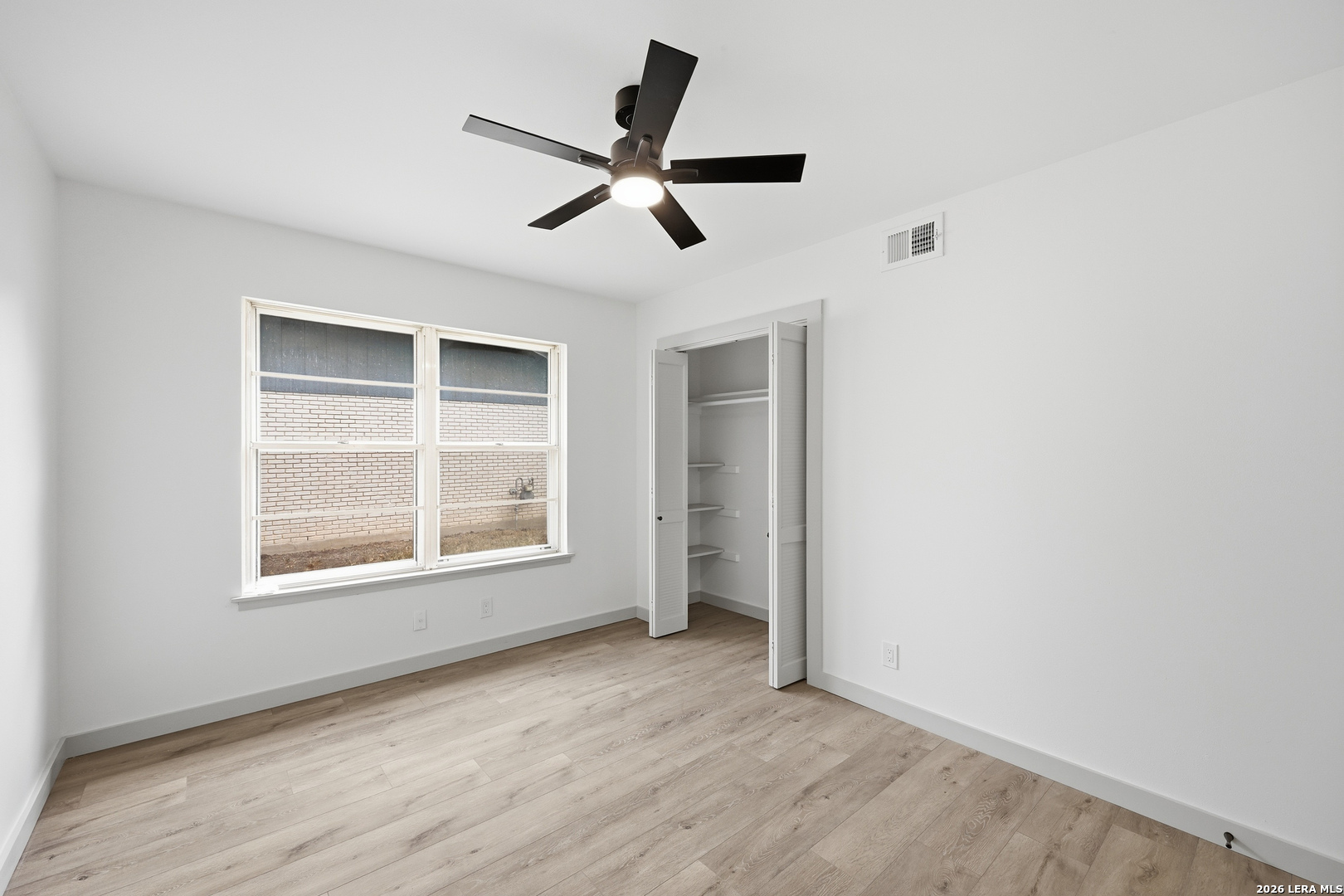 426 Zephyr Drive Windcrest, TX 78239 - Photo 24 of 33 an empty room with wooden floor fan and windows