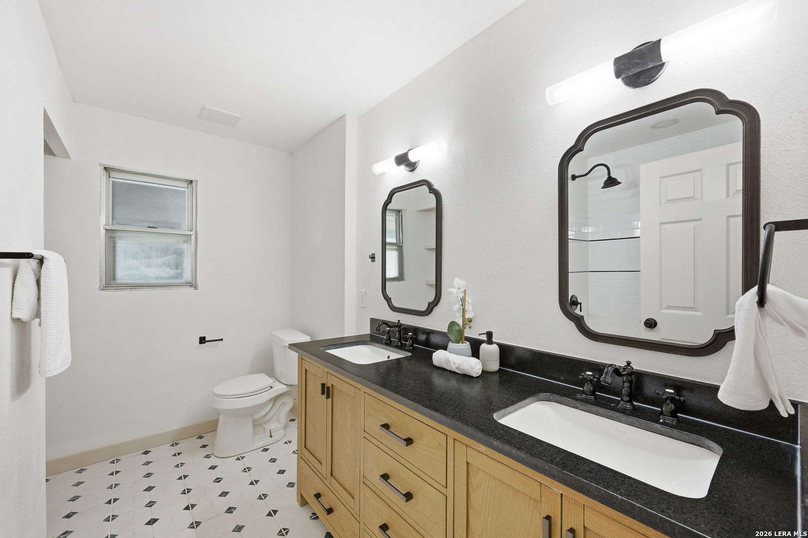 426 Zephyr Drive Windcrest, TX 78239 - Photo 26 of 33 a bathroom with a double vanity sink mirror and toilet