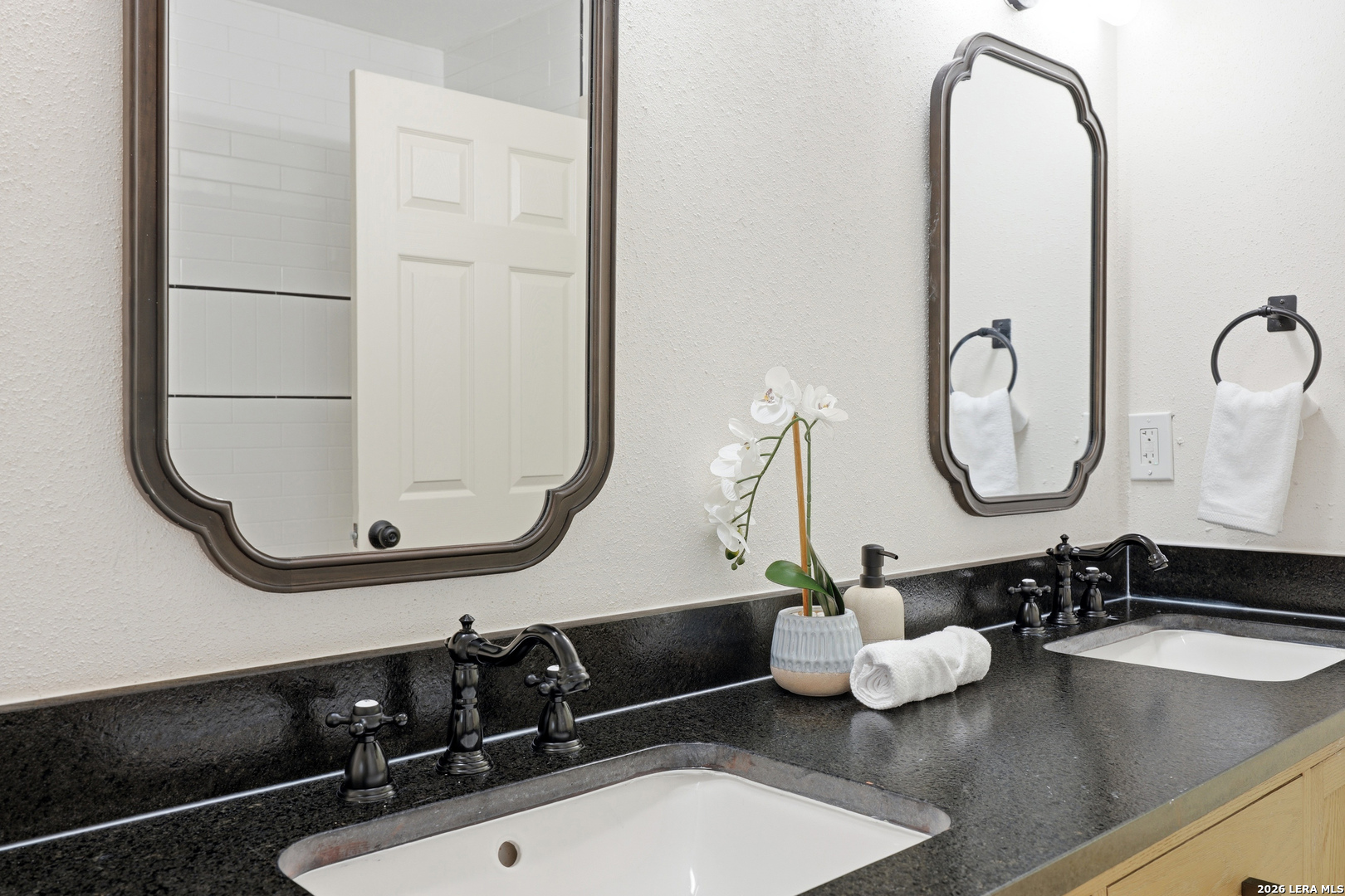 426 Zephyr Drive Windcrest, TX 78239 - Photo 28 of 33 a bathroom with a sink and a mirror
