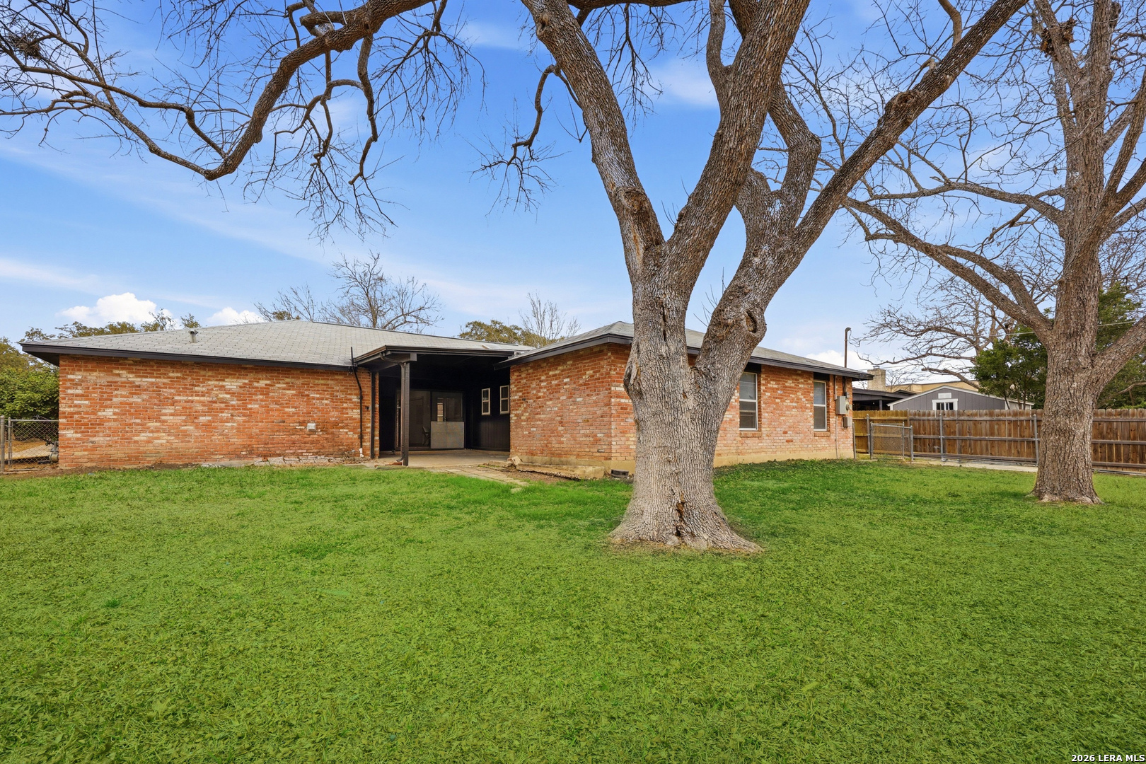 426 Zephyr Drive Windcrest, TX 78239 - Photo 32 of 33 a front view of a house with a garden and tree