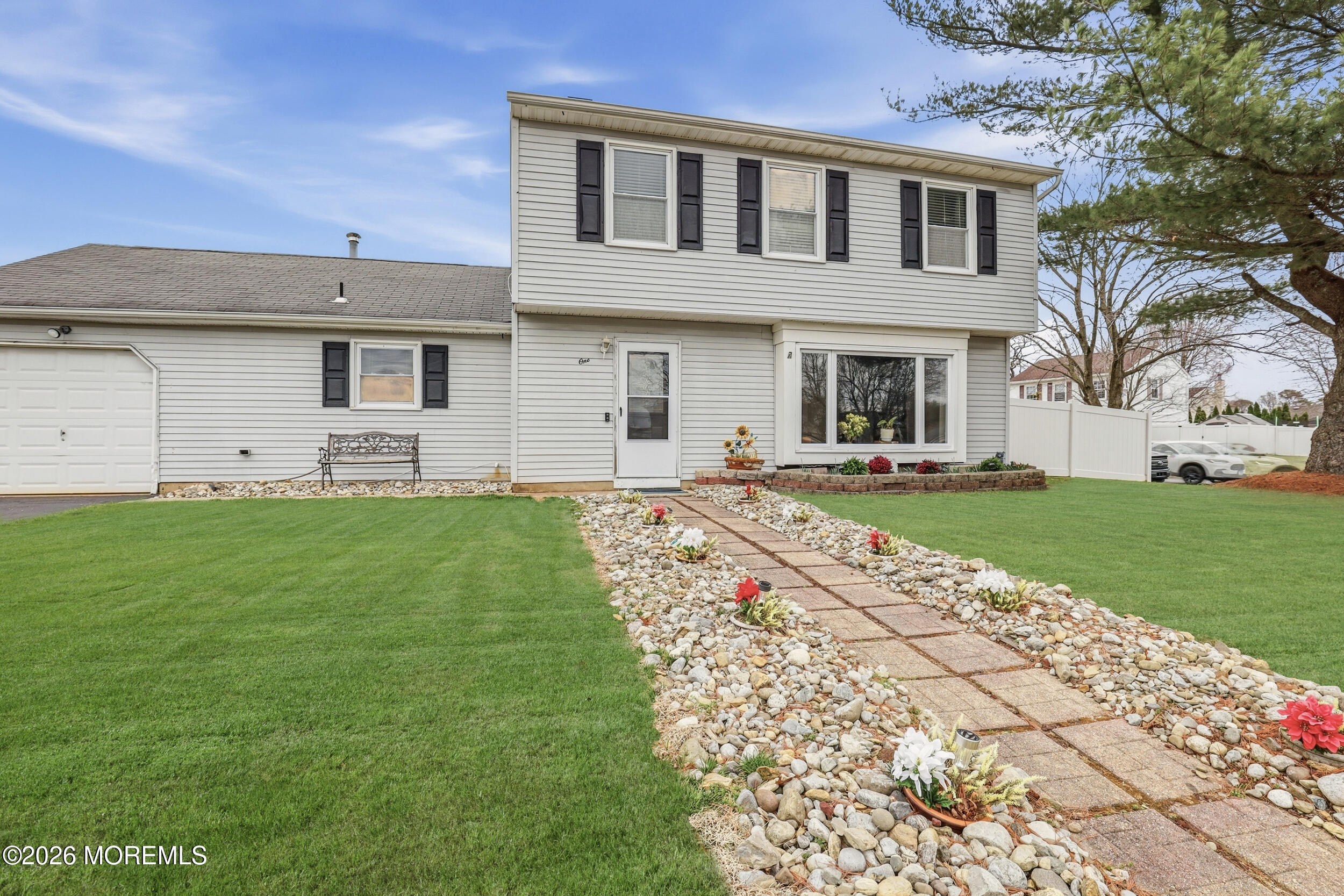 1 Mimi Lane Howell, NJ 07731 - Photo 2 of 26 a front view of a house with a yard