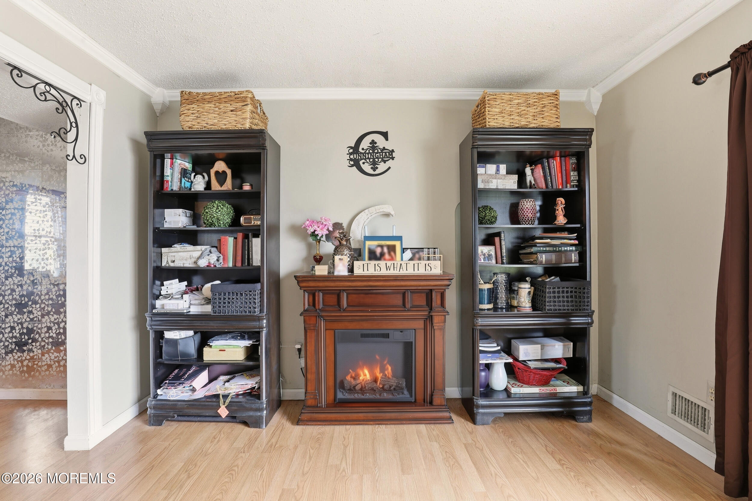 1 Mimi Lane Howell, NJ 07731 - Photo 10 of 26 a living room with furniture a bookshelf and a fireplace