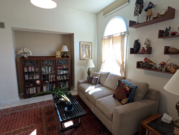 a living room with furniture a rug and a window