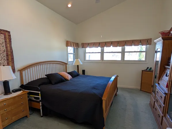 a bedroom with bed and a window