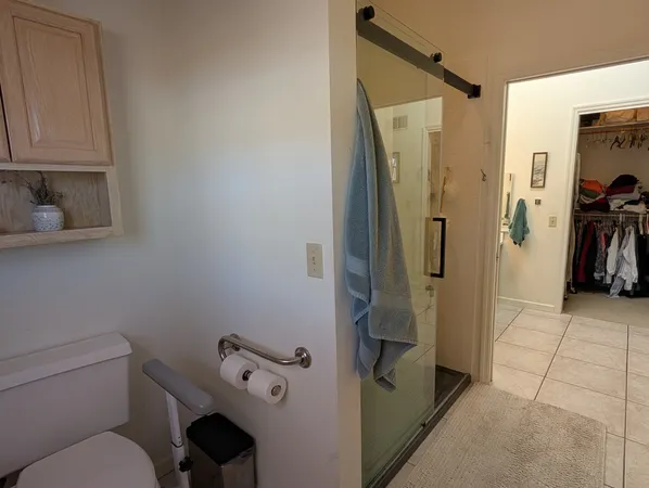 a bathroom with a toilet and a shower