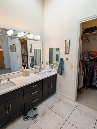a bathroom with a double vanity sink and a mirror